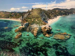 an aerial view of a beach with rocks in the water at Belvedere Residenza Mediterranea in Portoferraio