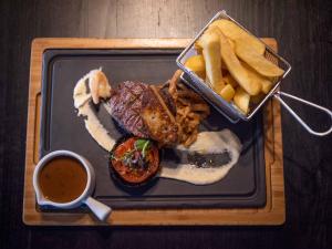 a plate of food with a sandwich and french fries at Midlands Park Hotel in Portlaoise