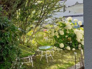 einen Tisch und Stühle in einem Garten mit Blumen in der Unterkunft Ferienwohnung im Fischerhäusle in Nonnenhorn