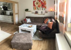 a living room with a couch and a table at Sommerhaus Boldevitz auf Rügen in Boldevitz +14 photos