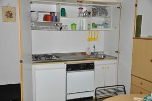a kitchen with a sink and a stove at Taormina Mare Appartamento 300 Metri dal Mare in Giardini Naxos