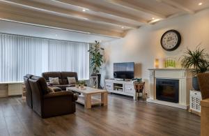 a living room with a couch and a fireplace at Sleep Inn Amsterdam in Amsterdam