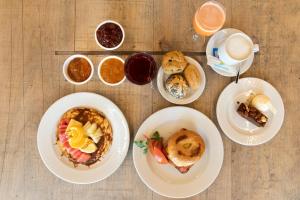 a table with plates of breakfast foods and drinks at Hotel Paradiso Garden in Playa de Palma