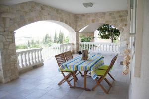 a table and chairs on the balcony of a house at Villa Anna in Nafpaktos