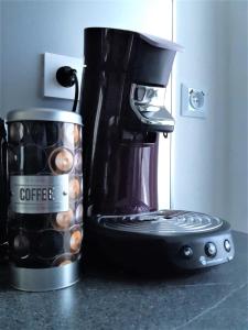 a coffee maker sitting on a counter next to a coffee pot at Comfort Stay Basel Airport 1A46 in Saint-Louis