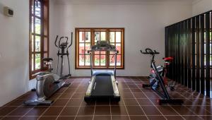 a gym with two treadmills and two exercise bikes at La Rivière d' Angkor Resort in Siem Reap