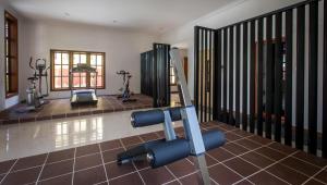 a gym with treadmills and exercise equipment in a room at La Rivière d' Angkor Resort in Siem Reap