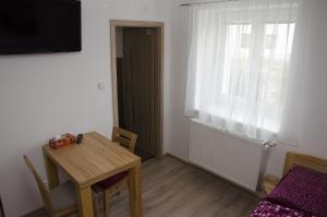 a small dining room with a table and a window at Ubytování Bor in Bor +6 photos