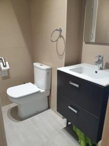 a bathroom with a toilet and a sink at Studio El Faro in Torrox Costa +21 photos