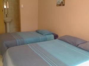 two beds sitting next to each other in a room at Element Riders Place Backpackers in Lüderitz
