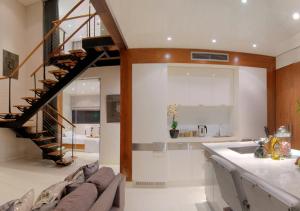 a kitchen and living room with a spiral staircase at Quayside Waterfront Apartment in Durban