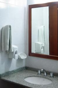 a bathroom with a sink and a mirror at Green House in Villa General Belgrano