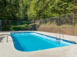 a blue swimming pool with a fence around it at Smoky Mtn Sunrise in Gatlinburg