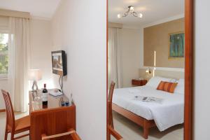 Postel nebo postele na pokoji v ubytování Hotel Michelangelo