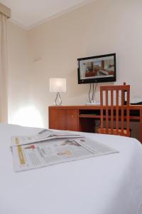 Postel nebo postele na pokoji v ubytování Hotel Michelangelo