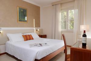Postel nebo postele na pokoji v ubytování Hotel Michelangelo