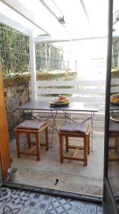 a table and two chairs and a table and bench at Maison Centre Ville Parking privé in Ax-les-Thermes