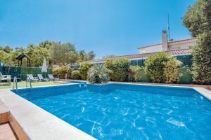 a swimming pool in a yard with a house at Rentalmar Costa Verde in Cambrils +30 photos