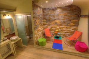 a bathroom with two chairs and a brick wall at Navona Dream in Rome +66 photos