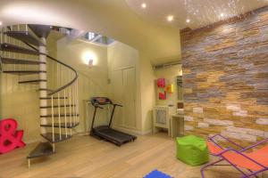 a room with a gym with a treadmill and a brick wall at Navona Dream in Rome
