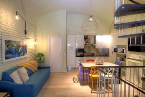 a living room and kitchen with a blue couch and a table at Navona Dream in Rome