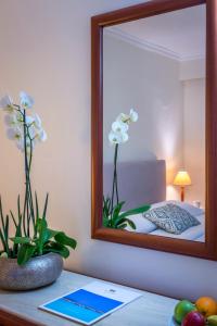 a mirror sitting on a table in front of a bedroom at Mitsis La Vita in Rhodes Town