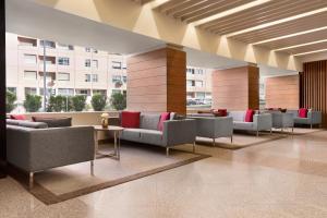 a lobby with couches and tables in a building at Ramada by Wyndham Lisbon in Lisbon