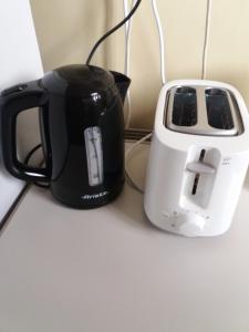a black and white toaster sitting next to a toaster at Katzen Room by the Metro in Athens