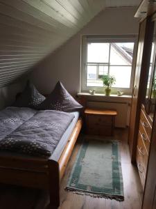 a small bedroom with a bed and a window at Ferienwohnung Deichsel in Sundern