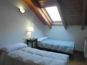 a living room with two beds and a window at B16 - Edif Ball Benás Dúplex - Villmor in Benasque