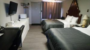 Rúm í herbergi á Port Motel