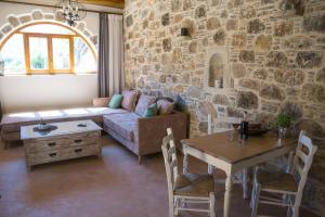 a living room with a couch and a table at To Spiti mas in Sougia