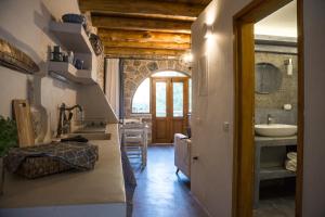 a bathroom with a sink and a mirror and a sink at To Spiti mas in Sougia