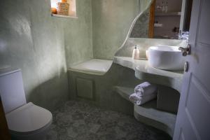 a bathroom with a sink and a toilet at To Spiti mas in Sougia