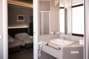 a bathroom with a sink and a bed at Plus Florence in Florence
