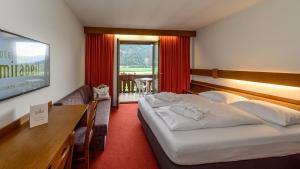A bed or beds in a room at Hotel Mirabell