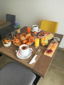 a table with breakfast foods and coffee on it at Hotel Residence Lido Marana in Furiani