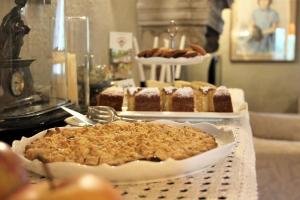 a table topped with cakes and desserts on a table at Il Pignocco Country House in Santa Veneranda +45 photos