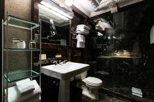 a bathroom with a sink and a toilet and a shower at City Club Hotel in New York