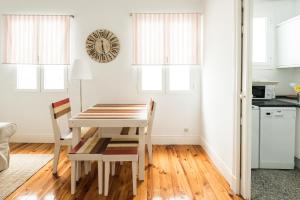 a kitchen with a table and chairs in a room at Apartamentos Alcalá in Madrid