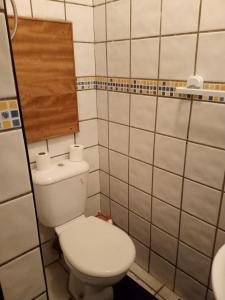 a small bathroom with a toilet and a mirror at Centre ville Avenue Hassan II in Agadir