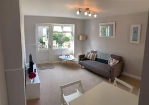 a living room with a couch and a table at Harbour Lights in Penzance