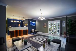 a living room with two tables and a kitchen at Sherlock Holmes Boutique Hotel in Lviv