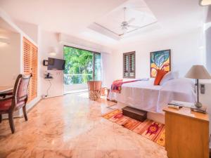 a bedroom with a white bed and a desk and a desk at Villa Divina Luxury in Puerto Vallarta