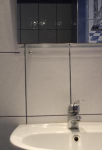 a bathroom with a sink and a mirror above it at La Luna Studios in Neos Marmaras