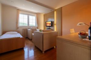 a small room with a bed and a desk in it at Villa Natalia in Neum