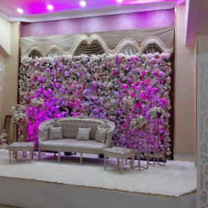 a wall of flowers with a couch in front of it at Numidien Hotel in Alger