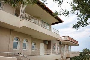 a building with balconies on the side of it at OLIVE & SEA in Nea Moudania