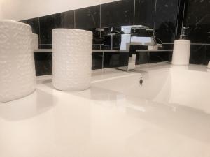 a bathroom with three rolls of toilet paper on a counter at Cala Caterina Rooms in Villasimius +42 photos