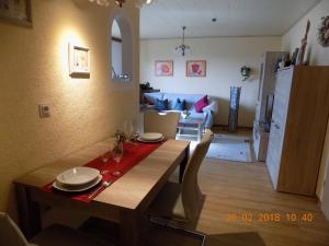 a dining room with a table and a living room at Haus Alexandra in Schöneberg
